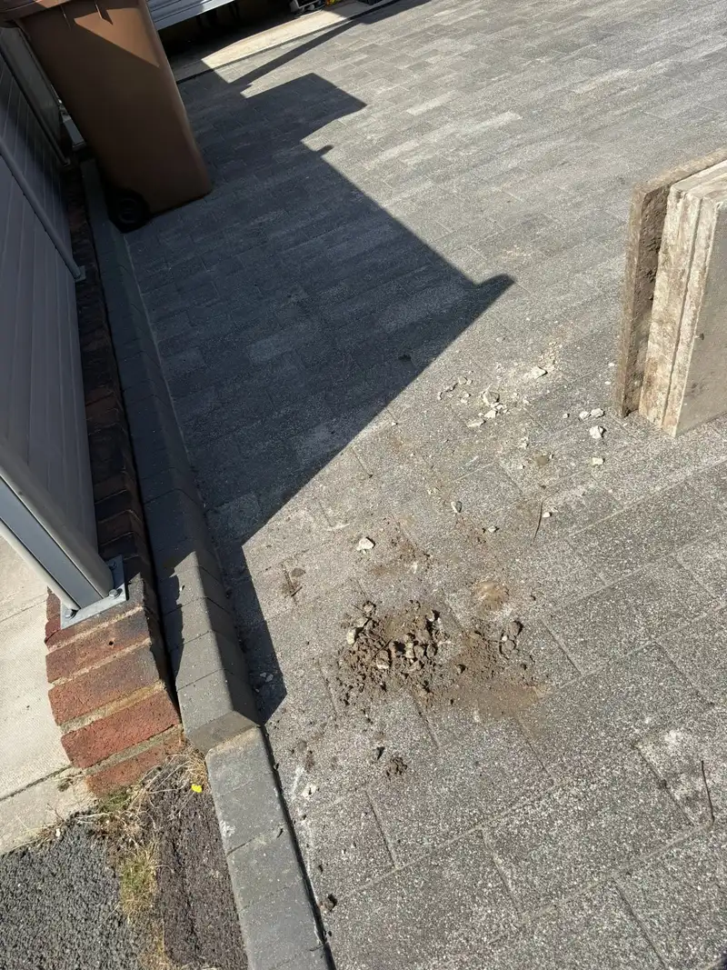 The same driveway after clearance, swept clean of rubble