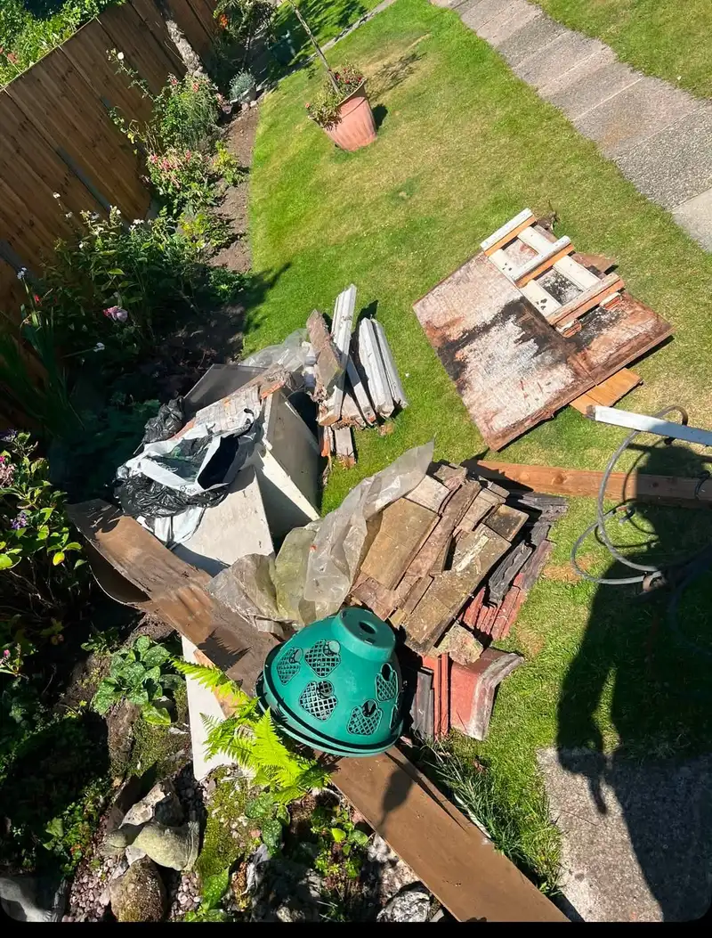 Garden waste, old shed panels and roof tiles cleared from a back garden
