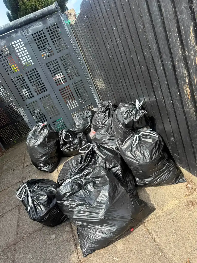 Bagged household waste stacked and ready for collection by King of Waste
